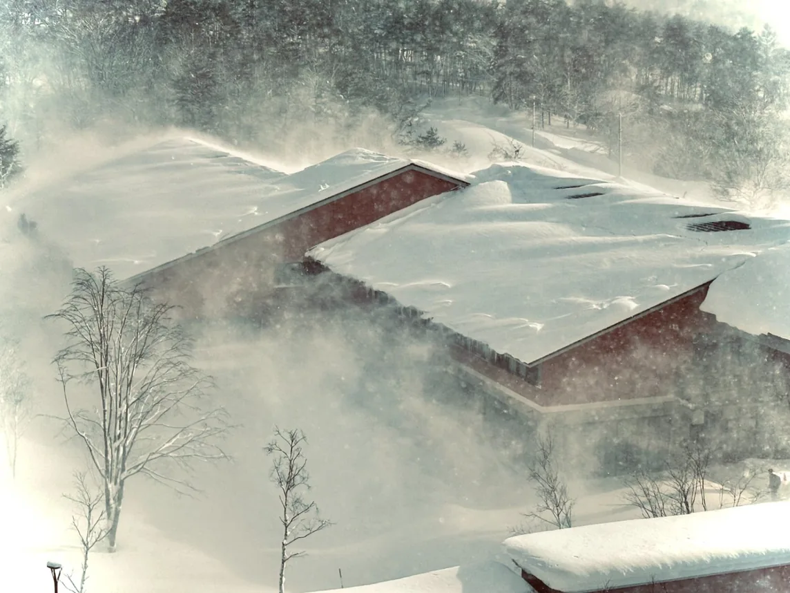 Snow blowing across the campus rooftops