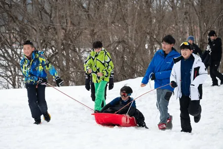 Students pulling a sledge on the snow